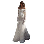 Graceful White Wedding Dress Features Floral Embellishments Long Sleeves With Deep V Neckline Flowing Fabric Creates Graceful