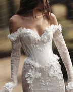 Graceful White Wedding Dress Features Floral Embellishments Long Sleeves With Deep V Neckline Flowing Fabric Creates Graceful